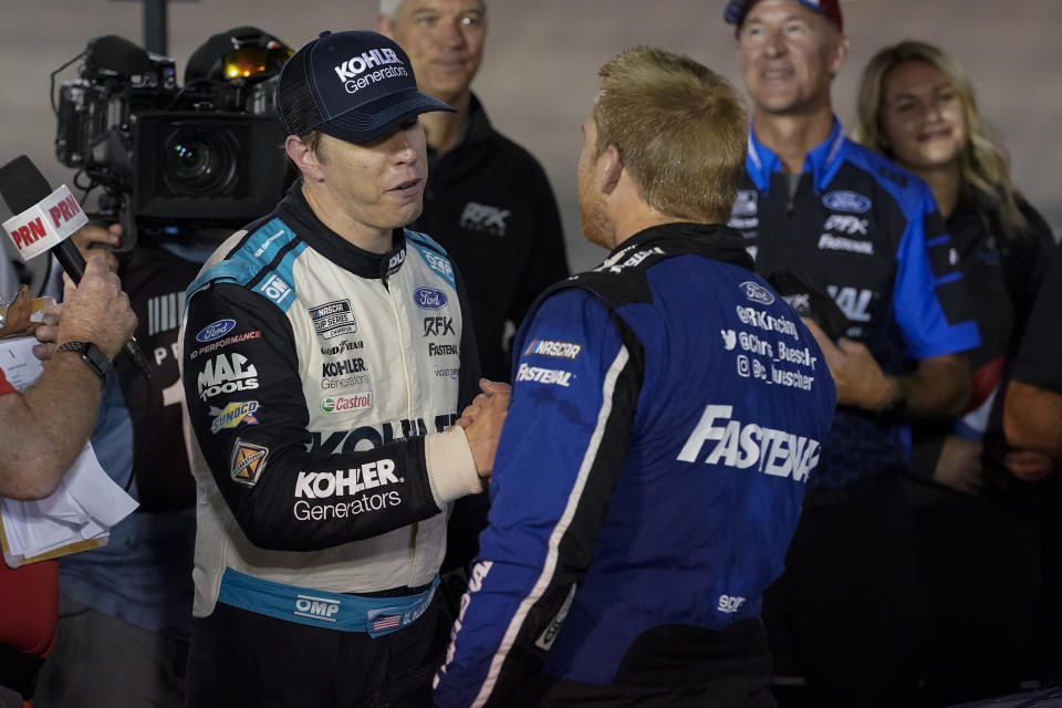 Brad Keselowski, left, congratulates Chris Buescher after Buescher won a NASCAR Cup Series auto race at Bristol Motor Speedway Saturday, Sept. 17, 2022, in Bristol, Tenn. (AP Photo/Mark Humphrey)