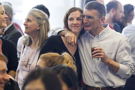 Aziz Sancar (R), a professor at the University of North Carolina-Chapel Hill, hugs Rose Peifer, his goddaughter, before a press conference for the state of North Carolina's Nobel laureates in Chapel Hill, North Carolina October 7, 2015. REUTERS/Ray Whitehouse