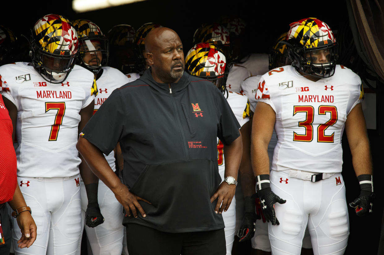 FILE - In this Sept. 14, 2019, file photo, Maryland head coach Michael Locksley, center, looks on as he is about to lead his team out of the tunnel for the first half of an NCAA college football against Temple, in Philadelphia. For good reason, Maryland first-year coach Mike Locksley has no desire to look into the past before leading the Terrapins into Friday night’s matchup with No. 12 Penn State. Locksley insists recent results in the terribly lopsided Penn State-Maryland series will have no bearing on what happens before a rare sellout crowd in College Park for the Big Ten opener. Funny thing is, Nittany Lions coach James Franklin agrees with the assessment.(AP Photo/Chris Szagola, File)