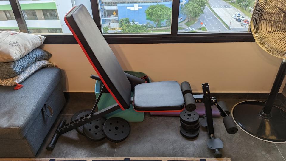 A picture of a black workout bench in a living room. (Photo: Yahoo Lifestyle Singapore)