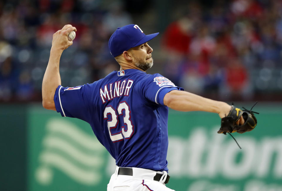 Texas Rangers starting pitcher Mike Minor throws to a Houston Astros batter during the first inning of a baseball game in Arlington, Texas, Wednesday, April 3, 2019. (AP Photo/Tony Gutierrez)