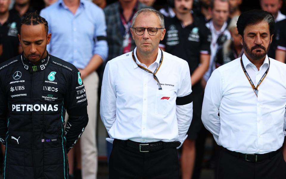 Lewis Hamilton of Great Britain and Mercedes, Stefano Domenicali, CEO of the Formula One Group, and Mohammed ben Sulayem, FIA President, are pictured as Formula 1 holds a minutes silence in mourning of Queen Elizabeth II prior to practice ahead of the F1 Grand Prix of Italy at Autodromo Nazionale Monza on September 09, 2022 in Monza, Italy - Formula 1/Formula 1 via Getty Images)