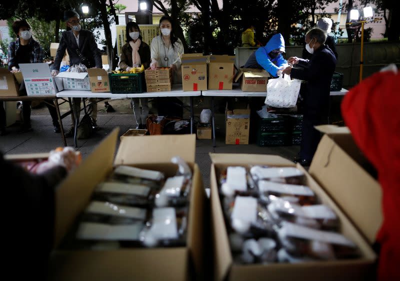 Volunteers take part in food aid handouts, as the spread of the coronavirus disease (COVID-19) continues in Tokyo