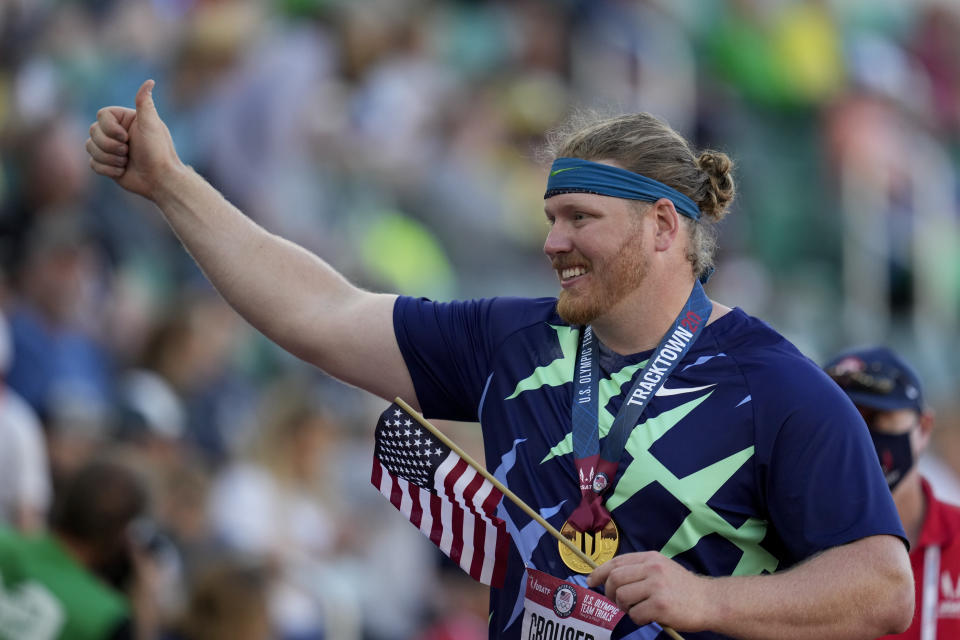 Ryan Crouser celebrates during a victory lap, after setting a world record during the finals of men's shot put at the U.S. Olympic Track and Field Trials Friday, June 18, 2021, in Eugene, Ore. (AP Photo/Ashley Landis)