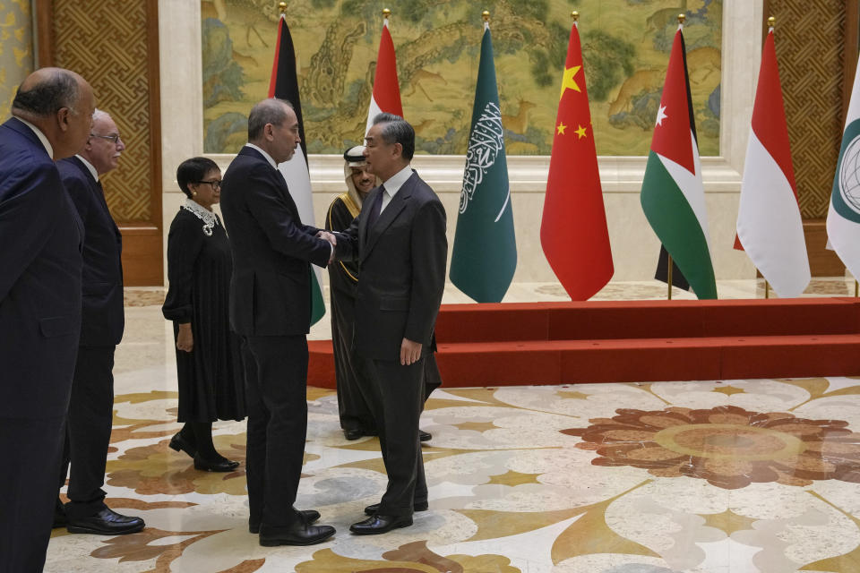 Foreign Ministers from five Arab and Islamic countries From left, Egyptian Foreign Minister Sameh Shoukry, Palestine Foreign Minister Riyad al-Maliki, Indonesian Foreign Minister Retno Marsudi, Jordanian Deputy Prime Minister and Foreign Minister Ayman Safadi, Saudi Arabia's Foreign Minister Faisal bin Farhan Al Saud is greeted by Chinese Foreign Minister Wang Yi before their meeting at the Diaoyutai state guesthouse in Beijing, Monday, Nov. 20, 2023. China's foreign minister welcomed five Arab and Islamic counterparts to Beijing on Monday, saying his country would work with "our brothers and sisters" in the Arab and Islamic world to try to end the fighting in Gaza as soon as possible. (AP Photo/Andy Wong)