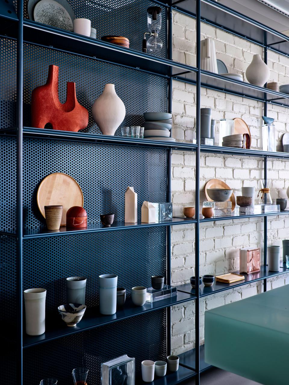 The ceramic cups and plates are made by Studio Enti and the glassware is by Saardé Homewares. The sculptural vases and vessels are by Greg Natale, Jane Vogel, and Katrina Wells.