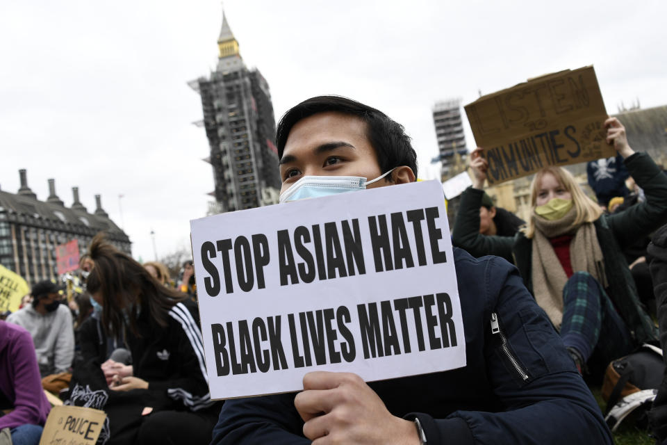 Demonstrators holding posters and flags gather at Parliament Square during a 'Kill the Bill' protest in London, Saturday, April 3, 2021. The demonstration is against the contentious Police, Crime, Sentencing and Courts Bill, which is currently going through Parliament and would give police stronger powers to restrict protests. (AP Photo/Alberto Pezzali)