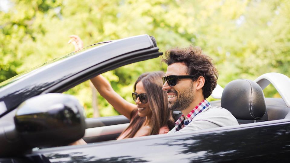 Couple in convertible on their road trip.