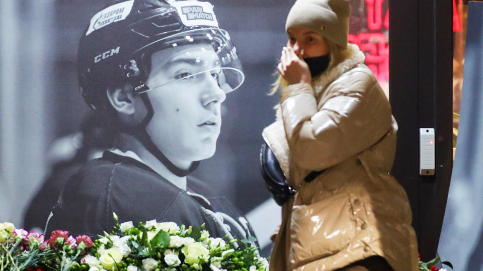 A woman, pictured here at a makeshift memorial to Timur Faizutdinov.