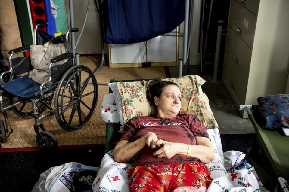 Melody Barnett rests at an American Red Cross shelter for McKinney Fire evacuees in Weed, Calif., on Monday, Aug. 1, 2022. She is waiting to return home to Yreka. (AP Photo/Noah Berger)