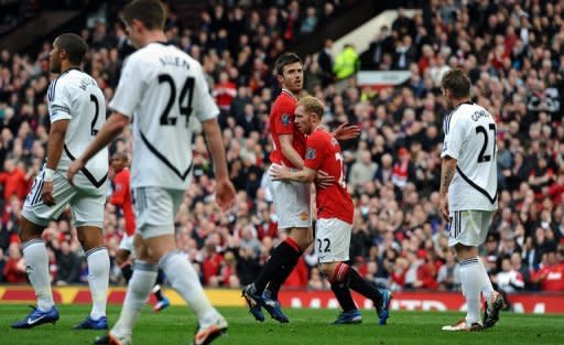 Manchester United's Michael Carrick (3rd R) congratulates goal-scorer Paul Scholes (2nd R) during their Premier League match against Swansea City on May 6. Scholes gave United a 28th-minute lead after turning in a shot from Carrick