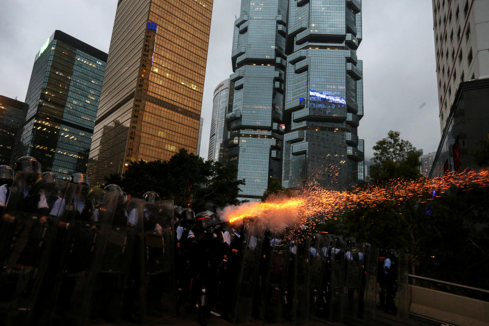 Police officers fire tear gas during a demonstration against a proposed extradition bill in Hong Kong, China June 12, 2019. REUTERS/Athit Perawongmetha