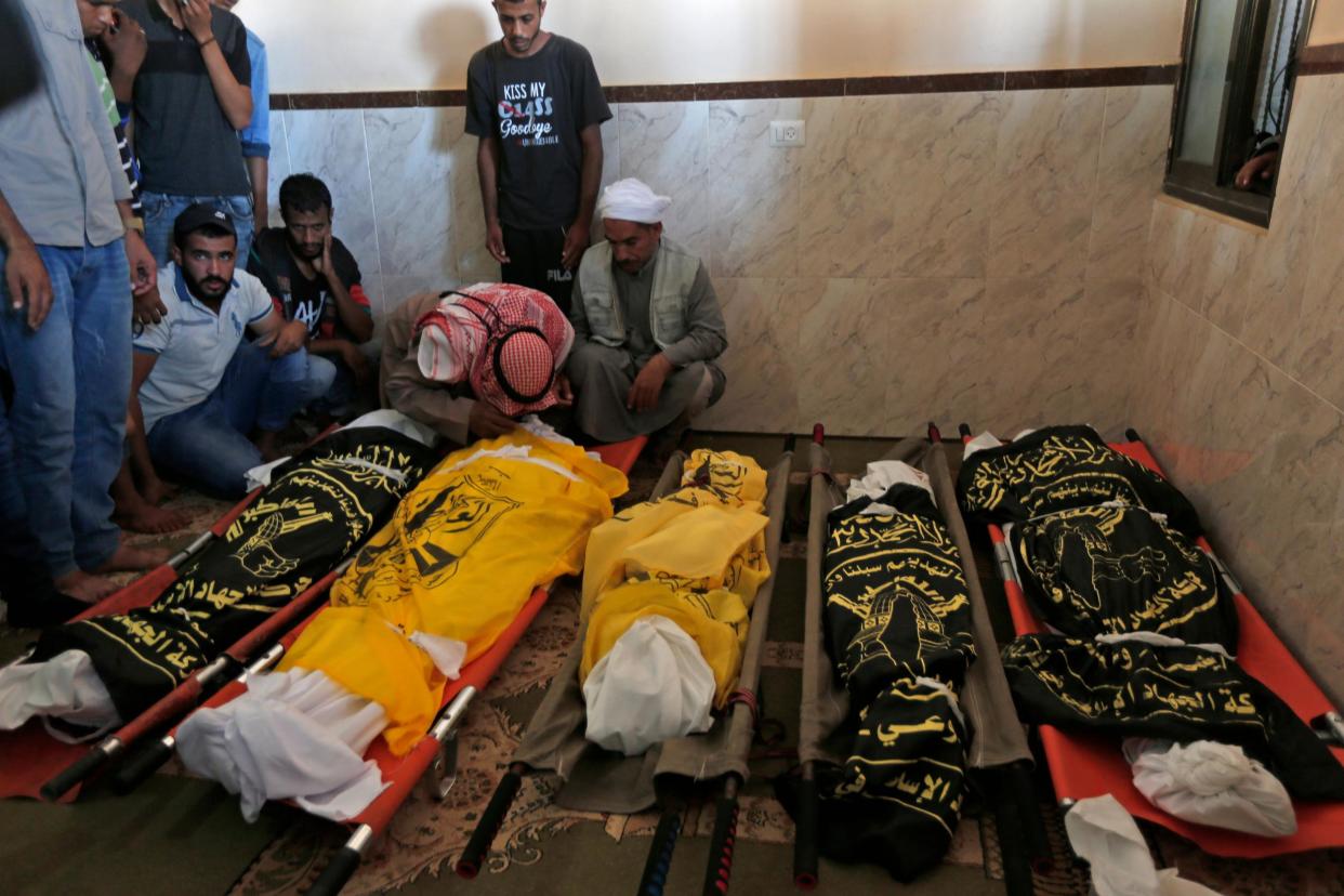 Palestinians mourn over the bodies of members of a family who were killed in an Israeli airstrike in Deir al-Balah: AFP/Getty