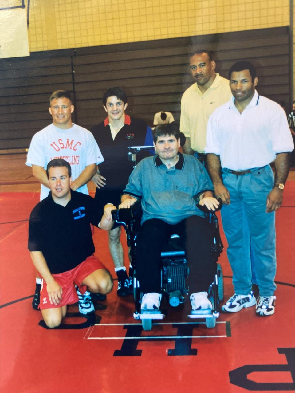 Matt Moore (center) photographed with (from left to right) Peekskill alumnus Chris Ball (kneeling), Marine Corps and Olympic coach Jay Antoinelli, 1996 Olympic gold medalist Kendall Cross, 1984 Olympic silver medalist Greg Gibson, and Peekskill alumnus Gene Clemons.