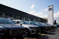 Geely vehicles and logo are seen at a car dealership in Shanghai