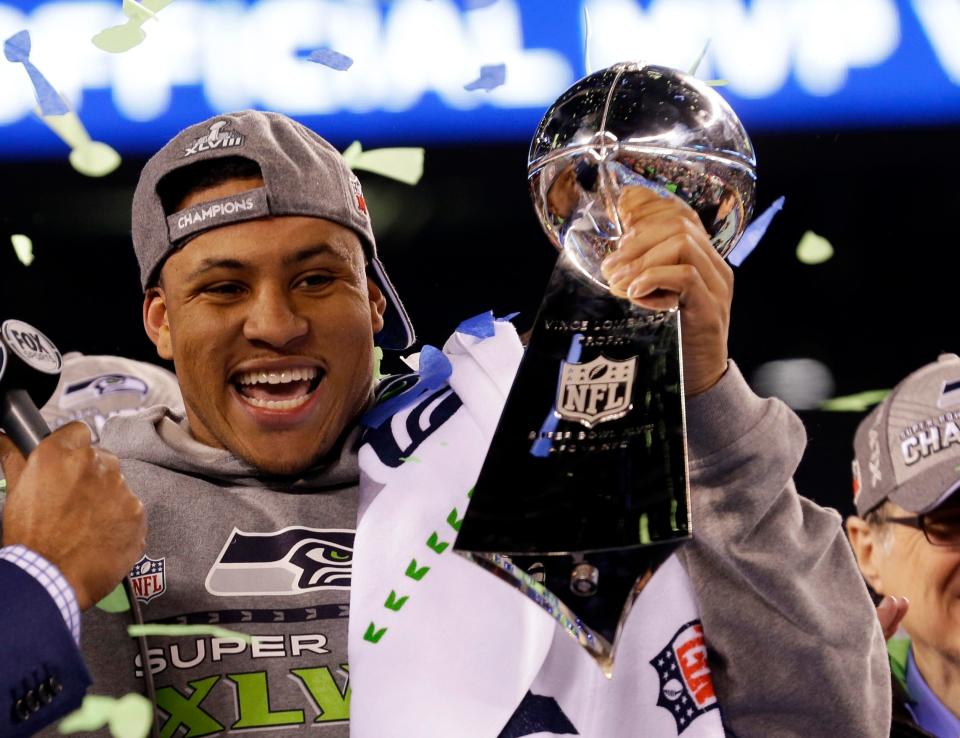 Seattle Seahawks' Malcolm Smith celebrates with the Vince Lombardi Trophy after the NFL Super Bowl XLVIII football game against the Denver Broncos, Sunday, Feb. 2, 2014, in East Rutherford, N.J. The Seahawks won 43-8. AP Photo/Ted S. Warren