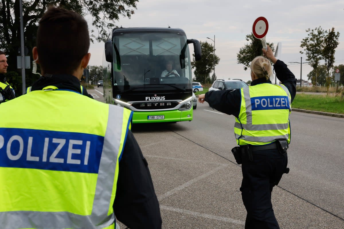 German police officers stop a bus at the border between Germany and France (The Associated Press)