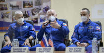 In this image provided by NASA, from left, U.S. astronaut Mark Vande Hei, Russian cosmonauts Oleg Novitsky and Pyotr Dubrov, members of the main crew to the International Space Station (ISS), attend a news conference in the Baikonur Cosmodrome, Kazakhstan, Thursday, April 8, 2021. (Bill Ingalls/NASA via AP