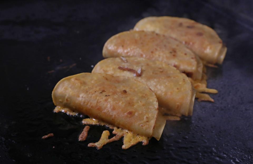 Fidelio Rita, chef and co-owner of Neno's Gourmet Mexican Street Food, finishes his birria tacos with cheddar cheese on the outside for extra crunch.