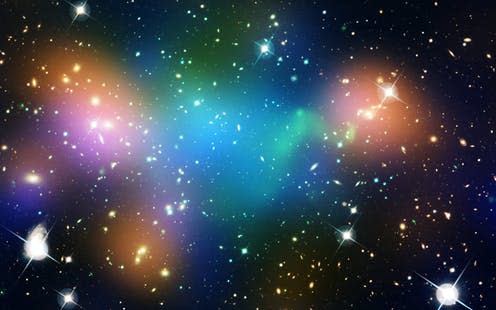 <span class="caption">The galaxy cluster Abell 520, with suspected dark matter highlighted in blue.</span> <span class="attribution"><span class="source">NASA</span></span>