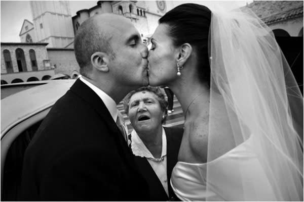 <div class="caption-credit">Photo by: Carlo Carletti</div><div class="caption-title">The Kiss-Off</div><p> As if kissing in front of 150 of your closest friends and family members wasn't nerve-wracking enough, then you've got this lady. </p> <p> <i>Have a photobomb of your own that you'd like to share? Upload your pic to</i> <i><span>BG's Facebook page</span> or</i><i><span>submit it to us via Instagram</span> (be sure to include the hashtag #bgphotobombs) and we may add it to our list!</i> </p>