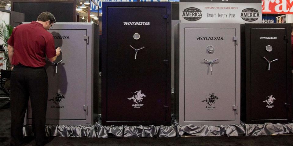 PHOTO: A Winchester Safes representative sets the lock on one of several gun safes on display at the 35th annual SHOT Show, Jan. 15, 2013, in Las Vegas. (Julie Jacobson/AP)