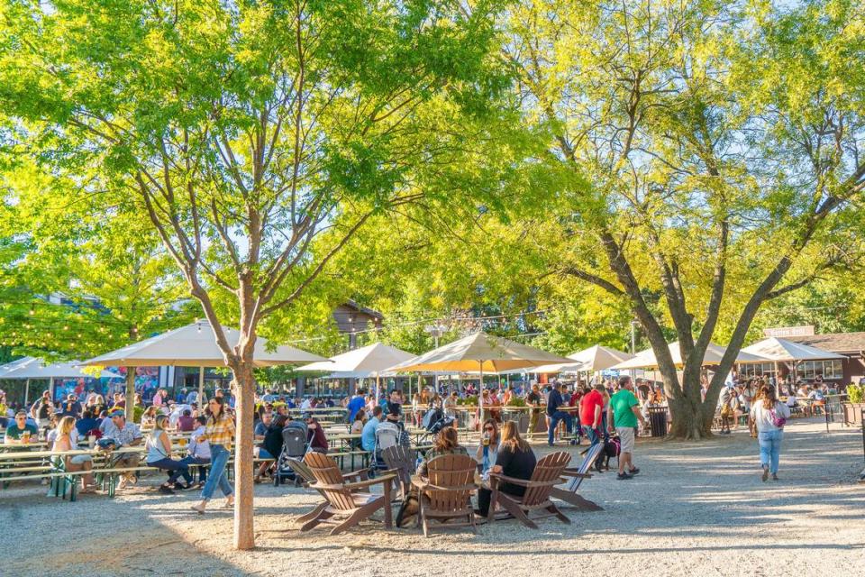 Olde Mecklenburg Brewery customers enjoy German-style beer outside the business in Charlotte. Madison Communities is planning to build more than 300 apartments near its Lower South End location. Olde Mecklenburg Brewery