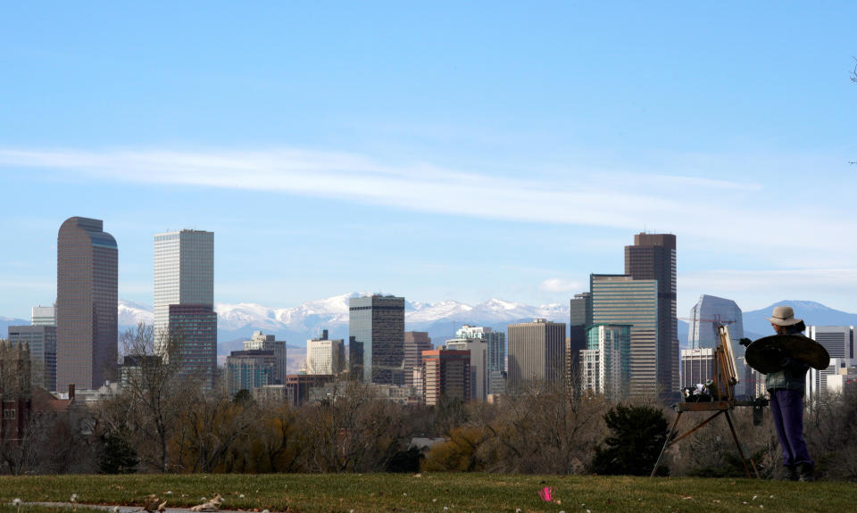 Dawn Cohen works on an oil painting of downtown Denver, in City Park in Denver, Colorado, U.S., November 16, 2017. REUTERS/Rick Wilking