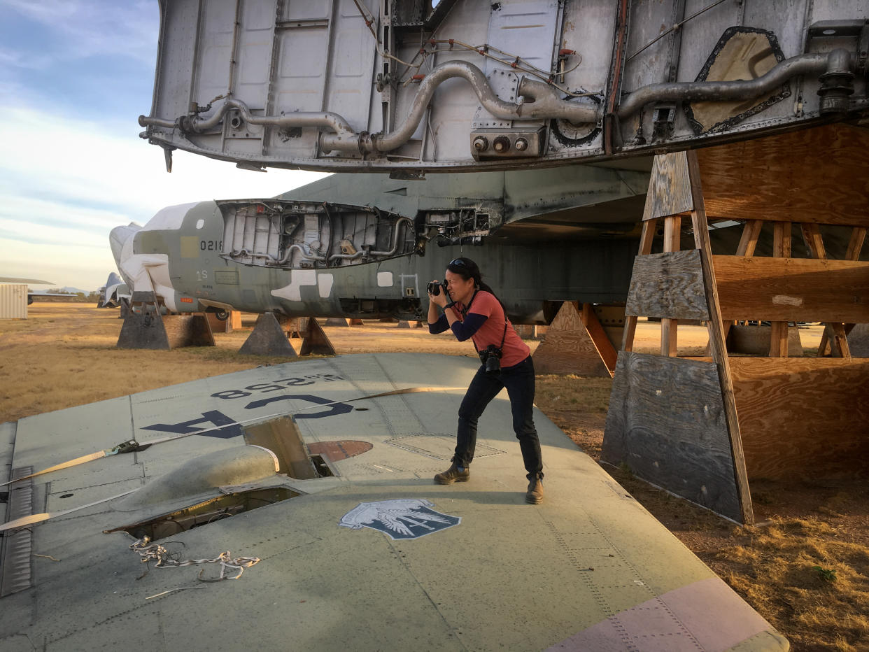 Sim Chi Yin photographs a decommissioned B52 Bomber at the Davis-Monthan Air Force Base Boneyard in Tucson, Arizona on 20 November, 2017. B52 bombers were designed to carry nuclear weapons and are still in service in the United States Air Force today. (PHOTO: Gabriel Ellison-Scowcroft)