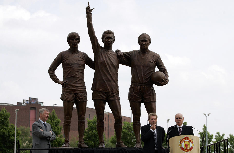 FILE - Ex-Manchester United players Bobby Charlton, bottom right, and Denis Law, bottom 2nd right, watched by Manchester manager Alex Ferguson, bottom left, speak, after the unveiling of the new statues of left to right, George Best, Denis Law and Bobby Charlton called "Holy Trinity", in memory of United's 40th anniversary of their first European Cup win over Benfica, at Old Trafford Stadium, Manchester, England, May 29, 2008. Bobby Charlton, an English soccer icon who survived a plane crash that decimated a Manchester United team destined for greatness to become the heartbeat of his country's 1966 World Cup-winning team, has died. He was 86. A statement from Charlton's family, released by United, said he died Saturday Oct. 21, 2023 surrounded by his family. (AP Photo/Paul Thomas, File)