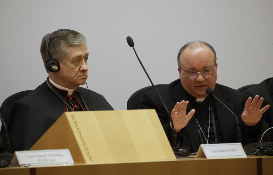 Malta's Archbishop Charles Scicluna, right, answers reporters' questions, flanked by Cardinal Blase J. Cupich, Chicago Archbishop, at a media briefing during a four-day sex abuse summit called by Pope Francis, in Rome, Friday, Feb. 22, 2019. Cardinals attending Pope Francis' summit on preventing clergy sex abuse called Friday for a new culture of accountability in the Catholic Church to punish bishops and religious superiors when they fail to protect their flocks from predator priests. (AP Photo/Alessandra Tarantino)