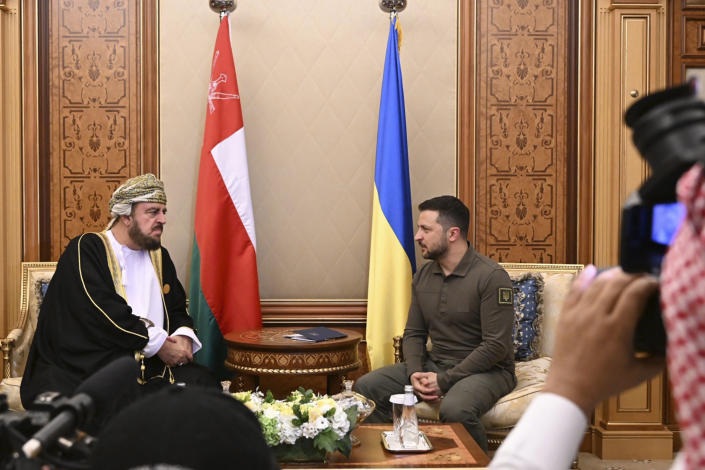 In this photo provided by Saudi Press Agency, SPA, Ukraine's President Volodymyr Zelenskyy, right, meets with Asaad bin Tariq bin Taimur Al Said, Deputy Prime Minister of Oman Sultanate during the Arab summit in Jeddah, Saudi Arabia, Friday, May 19, 2023. (Saudi Press Agency via AP)