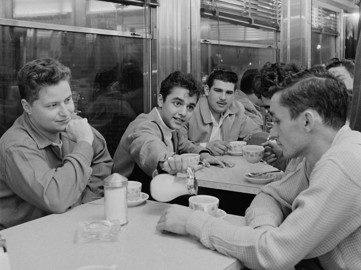 Men eating at a diner in January 1955