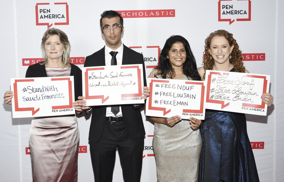 PEN America president Jennifer Egan, left, Walid Al-Hathloul, Lina Al-Hathloul and PEN America CEO Suzanne Nossel pose together holding signs in support of jailed Saudi women's rights activists Nouf Abdulaziz, Loujain Al-Hathloul and Eman Al-Nafjan at the 2019 PEN America Literary Gala at the American Museum of Natural History on Tuesday, May 21, 2019, in New York. (Photo by Evan Agostini/Invision/AP)