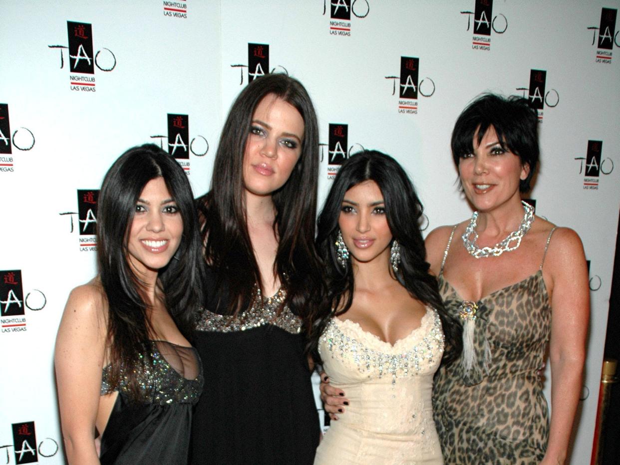 kourtney, khloé, and kim kardashian with kris jenner on a red carpet at TAO Las Vegas' First Princess Party in 2007. they're all wearing shorter dresses, and kris is in a cheetah print dress