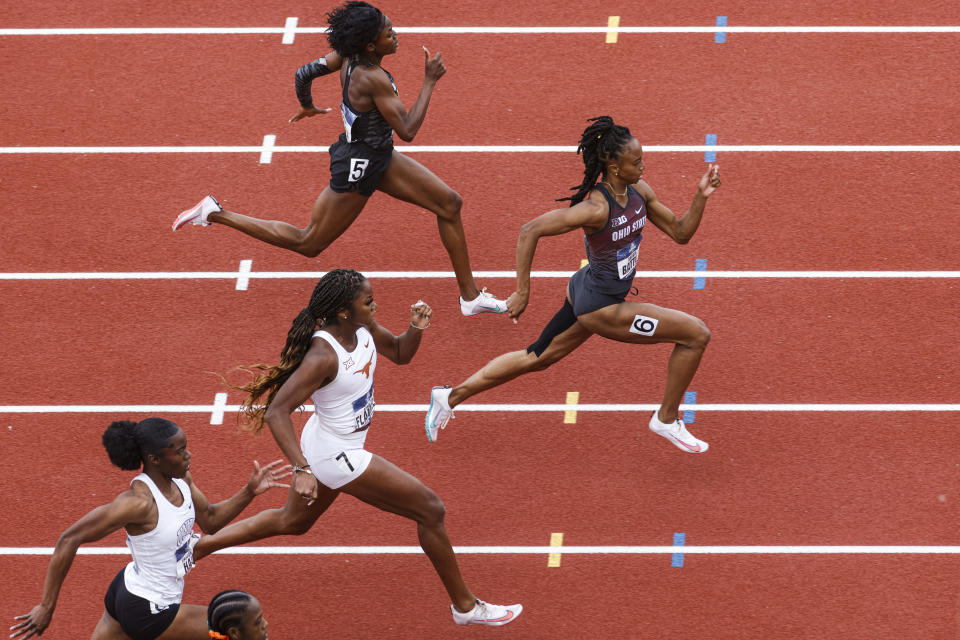 Runners compete in a preliminary heat of the women's 200 meters during the NCAA Division I Outdoor Track and Field Championships, Thursday, June 10, 2021, at Hayward Field in Eugene, Ore. Leading is Ohio State's Anavia Battle. (AP Photo/Thomas Boyd)