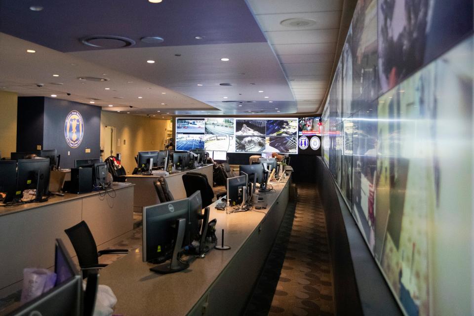 Live camera feeds from around the city are seen on a wall of screens in front of desks at the Memphis Police Department’s real time crime center on Wednesday, February 14, 2024.