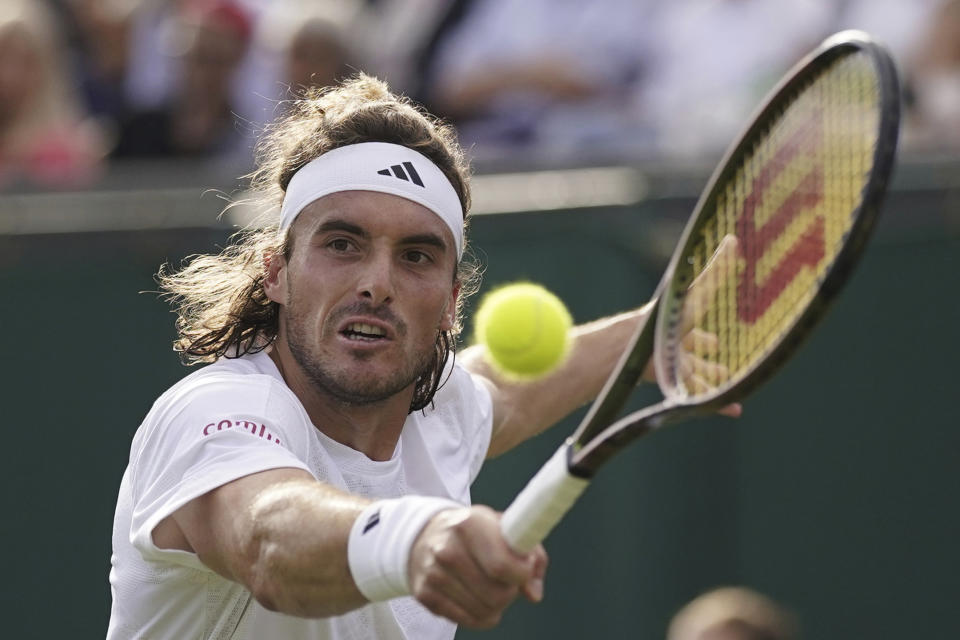 FILE - Stefanos Tsitsipas of Greece returns to Austria's Dominic Thiem in a first round men's singles match on day three of the Wimbledon tennis championships in London, Wednesday, July 5, 2023. Tsitsipas is one of the men to watch at the U.S. Open, which begins at Flushing Meadows on Aug. 28.(AP Photo/Alberto Pezzali, File)