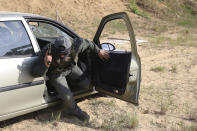 A volunteer from Belarus gets out of a car as he practices at a shooting range near Warsaw, Poland, on Friday, May 20, 2022. Belarusians are among those who have answered a call by Ukrainian President Volodymyr Zelenskyy for foreign fighters to go to Ukraine and join the International Legion for the Territorial Defense of Ukraine. (AP Photo/Michal Dyjuk)