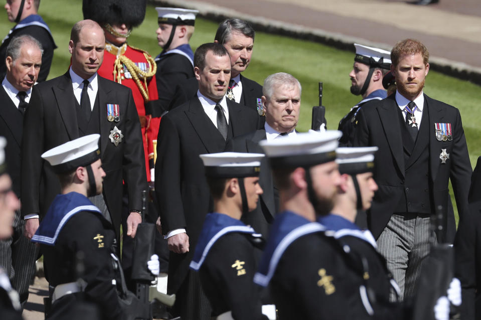 The Earl of Snowdon, Britain's Prince William, Peter Phillips, Vice Admiral Sir Timothy Laurence, Prince Andrew and Prince Harry, from left, follow the coffin as it slowly makes its way in a ceremonial procession during the funeral of Britain's Prince Philip inside Windsor Castle in Windsor, England, Saturday, April 17, 2021. (Gareth Fuller/Pool via AP)