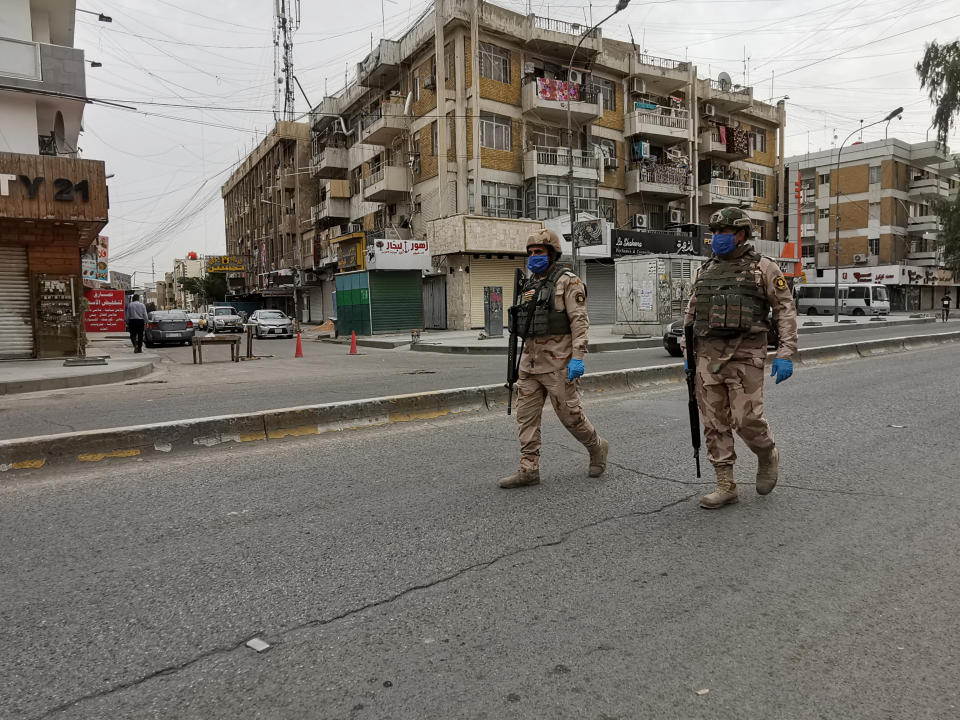 Iraqi security forces patrol to enforce a curfew to help fight the spread of the coronavirus in central Baghdad, Iraq, Tuesday, April 7, 2020. (AP Photo/Hadi Mizban)