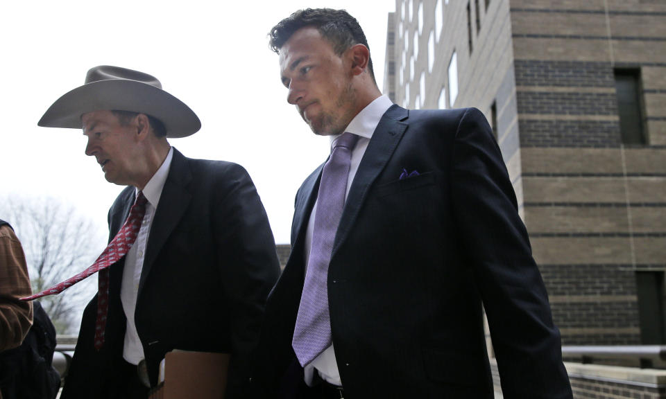 Former NFL quarterback Johnny Manziel, right, walks with his lawyer Jim Darnell after a court hearing in Dallas, Tuesday, Feb. 28, 2017. A Dallas County judge ordered Manziel to be at the hearing to address concerns about reports that he has violated terms of a plea agreement for a domestic violence case. (AP Photo/LM Otero)