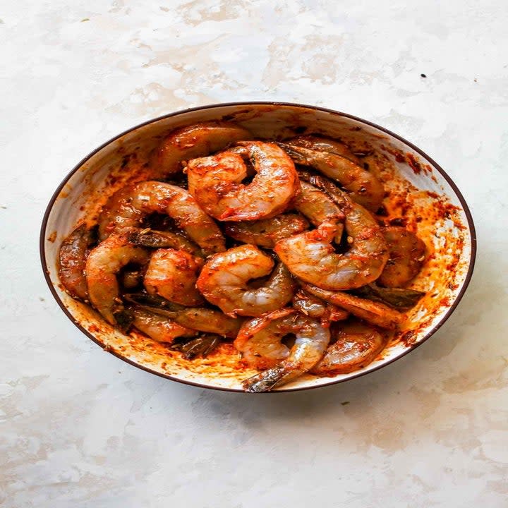Shrimp marinating in a bowl.
