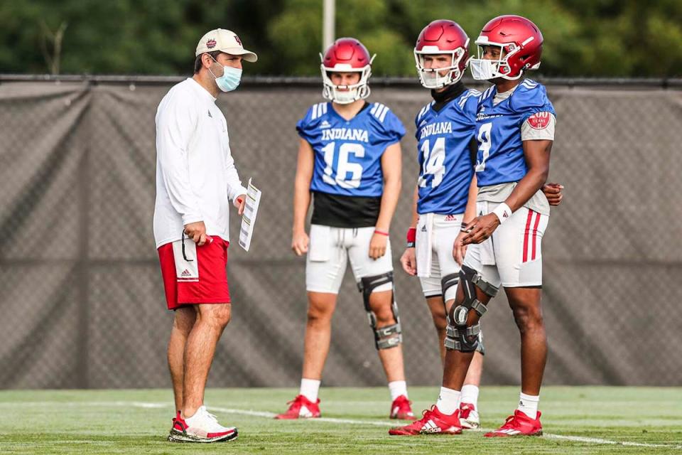 Indiana offensive coordinator Nick Sheridan talks with the quarterbacks, from left, Grant Gremel (16), Jack Tuttle (14) and Michael Penix (9) during fall camp at Memorial Stadium on Aug. 6.