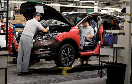 Workers are seen on the production line at Nissan's car plant in Sunderland Britain