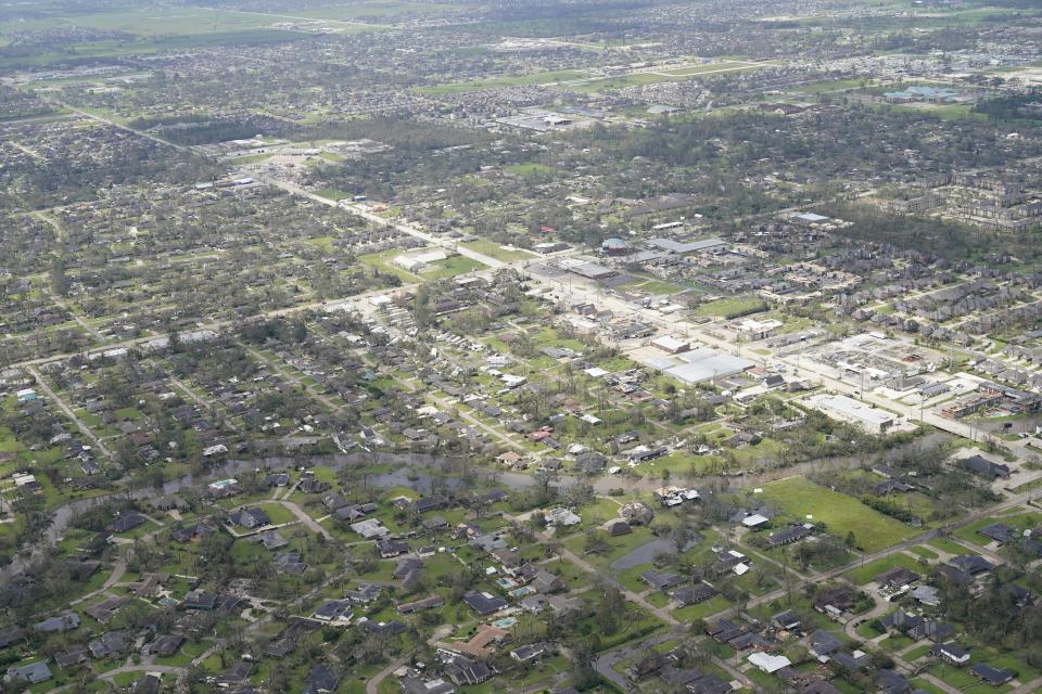 Blown down trees and debris surround damaged homes and buildings in the aftermath of Hurricane Laura Thursday, Aug. 27, 2020, near Lake Charles, La. (AP Photo/David J. Phillip)