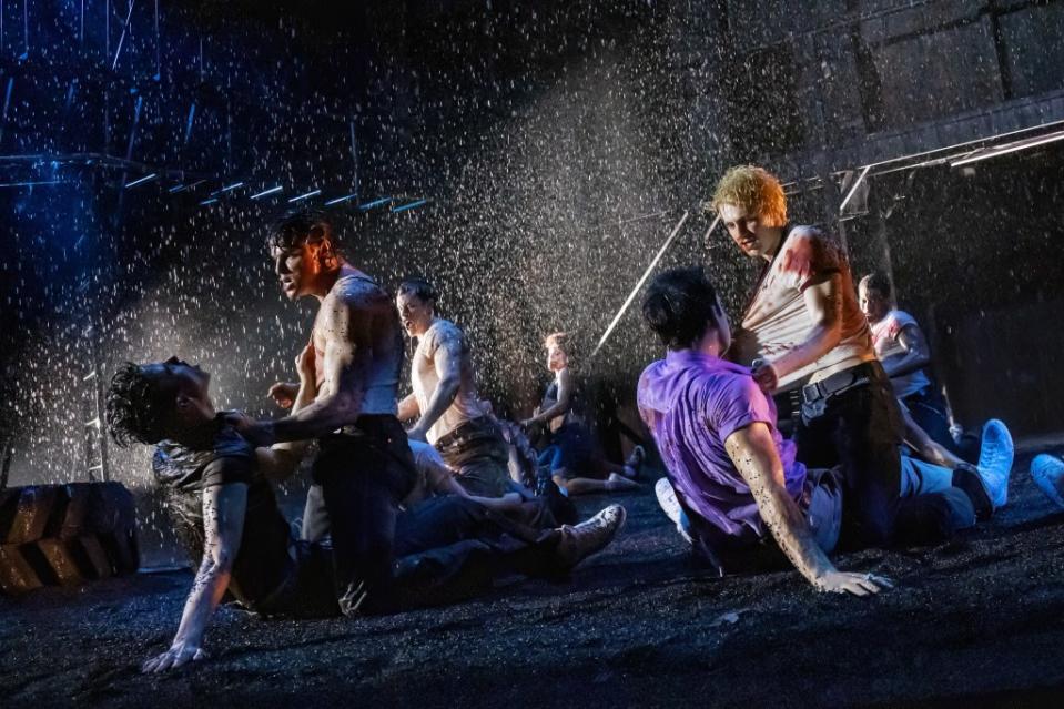 The cast of “The Outsiders” dramatically battles in the rain. Credit: © 2024, Matthew Murphy