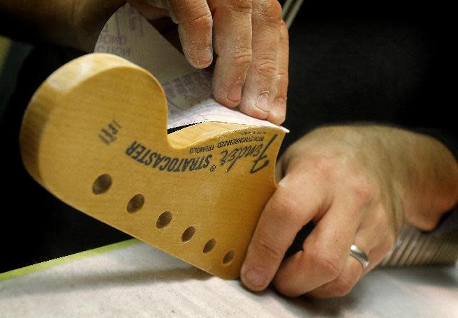 A Fender Stratocaster head stock is sanded in the Fender Custom Shop at the factory in Corona, Calif. on Tuesday, Oct. 15, 2013. Leo Fender developed the instrument in a small workshop in Fullerton, Calif. six decades ago. (AP Photo/Matt York)