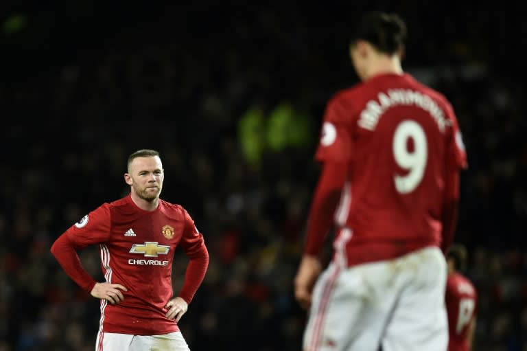 Manchester United's striker Wayne Rooney (L) anmd Manchester United's Swedish striker Zlatan Ibrahimovic react during the English Premier League football match against Hull City February 1, 2017