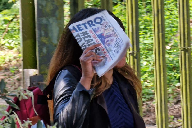 Akiwowo covered her face with a Metro newspaper as she left Snaresbrook Crown Court -Credit:MyLondon/Callum Cuddeford